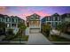 Charming two-story home featuring a two-car garage, well-manicured landscaping, and classic architectural details under a colorful sky at 496 West Palm Dr., Myrtle Beach, SC 29579