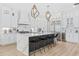 Modern kitchen with a large marble island, stylish pendant lighting, stainless steel appliances, and custom white cabinetry at 496 West Palm Dr., Myrtle Beach, SC 29579