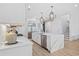 Bright, airy kitchen featuring a center island with marble countertops, stainless steel appliances, and contemporary pendant lighting at 496 West Palm Dr., Myrtle Beach, SC 29579