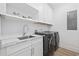 Well-organized laundry room with marble countertops, modern washing machine, and ample storage space at 496 West Palm Dr., Myrtle Beach, SC 29579