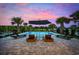 Relaxing outdoor pool area with lounge chairs and palm trees during sunset and featuring a great view at 496 West Palm Dr., Myrtle Beach, SC 29579