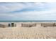 Tranquil beach scene with clear skies and ocean view, featuring access points and fencing at 504 N Ocean Blvd. # 1901, Myrtle Beach, SC 29577