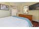 Comfortable bedroom with a large bed, wooden dresser and mirror, and artwork on the walls at 504 N Ocean Blvd. # 1901, Myrtle Beach, SC 29577