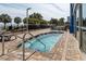 Close up of an outdoor hot tub with a steel railing, brick surround, lounge chairs and palms at 504 N Ocean Blvd. # 1901, Myrtle Beach, SC 29577