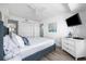 Bright bedroom with decorative pillows, luxury vinyl plank flooring, and a TV at 5511 N Ocean Blvd. # 1603, Myrtle Beach, SC 29577
