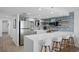 Spacious kitchen with bar seating, white cabinets, stainless steel appliances and wood tile flooring at 5511 N Ocean Blvd. # 1603, Myrtle Beach, SC 29577