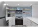 Modern kitchen featuring stainless steel appliances, quartz countertops, and stylish blue backsplash at 5511 N Ocean Blvd. # 1603, Myrtle Beach, SC 29577