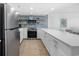Bright kitchen with white cabinets, stainless steel appliances, and quartz countertops at 5511 N Ocean Blvd. # 1603, Myrtle Beach, SC 29577