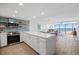 Modern kitchen with white cabinetry, stainless steel appliances, and stunning ocean views at 5511 N Ocean Blvd. # 1603, Myrtle Beach, SC 29577