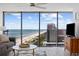 Bright living room with floor-to-ceiling windows offering stunning ocean views in this beachfront condo at 5511 N Ocean Blvd. # 1603, Myrtle Beach, SC 29577