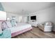 Well-lit main bedroom featuring luxury vinyl floors, white walls, and a comfortable chair at 5511 N Ocean Blvd. # 1603, Myrtle Beach, SC 29577