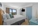 Bright bedroom featuring a TV, balcony with ocean view, and adjacent blue door at 5511 N Ocean Blvd. # 310, Myrtle Beach, SC 29577