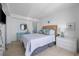 Cozy bedroom with white comforter, ocean-themed décor, and tiled floors at 5511 N Ocean Blvd. # 310, Myrtle Beach, SC 29577