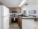 This eat-in kitchen includes wood cabinets, stainless steel appliances, and opens to living space with ocean views at 5511 N Ocean Blvd. # 310, Myrtle Beach, SC 29577