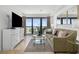 Well-lit living room with balcony access, ocean views, and a TV at 5511 N Ocean Blvd. # 310, Myrtle Beach, SC 29577