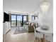 Sunlit living room features a pearl chandelier, ocean view, sofa and dining table for easy relaxation at 5511 N Ocean Blvd. # 310, Myrtle Beach, SC 29577