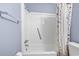 A clean bathroom with a white shower tub and floral shower curtain at 5905 South Kings Hwy. # A337, Myrtle Beach, SC 29575