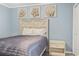 Cozy bedroom decorated with beach-themed accents, a queen bed, and simple nightstand at 5905 South Kings Hwy. # A337, Myrtle Beach, SC 29575
