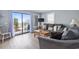 Bright living room with a sliding glass door to balcony and a comfortable seating area at 5905 South Kings Hwy. # A337, Myrtle Beach, SC 29575
