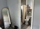 Bright bathroom featuring a toilet, shower with curtain and shelving for storage at 613 Todd Blvd., Conway, SC 29526