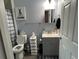 Bathroom featuring a toilet, vanity with sink, and shower behind a patterned curtain at 613 Todd Blvd., Conway, SC 29526