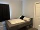 Bedroom featuring a bed with neutral colored bedding and a dark curtained window at 613 Todd Blvd., Conway, SC 29526