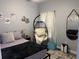 Bedroom features a bed with purple sheets, and a hanging egg chair at 613 Todd Blvd., Conway, SC 29526