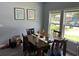 Bright dining room with a wooden table, chairs, and large windows providing natural light at 613 Todd Blvd., Conway, SC 29526