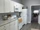 Kitchen with white cabinets, modern appliances and a view into the laundry area at 613 Todd Blvd., Conway, SC 29526