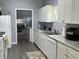 Well-lit kitchen featuring white cabinets, light countertops, and modern appliances for cooking at 613 Todd Blvd., Conway, SC 29526