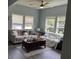 Bright living room featuring large windows, hardwood flooring, and comfortable couches with throw pillows at 613 Todd Blvd., Conway, SC 29526