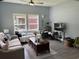 Inviting living room with modern furnishings, plush sofas, decorative pillows, and a ceiling fan at 613 Todd Blvd., Conway, SC 29526