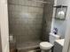 Tiled shower features a rainfall showerhead and built in shelving for toiletries at 613 Todd Blvd., Conway, SC 29526