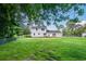 Expansive, fenced backyard features a well-maintained lawn and a wooden deck at 66 Johnstone Ln., Georgetown, SC 29440