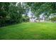A sprawling backyard featuring lush green grass and mature trees provides privacy at 66 Johnstone Ln., Georgetown, SC 29440