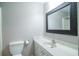 Bathroom featuring a white vanity, decorative framed mirror, and toilet at 66 Johnstone Ln., Georgetown, SC 29440