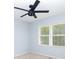 A light-filled bedroom features neutral walls, large windows, carpet and a ceiling fan at 66 Johnstone Ln., Georgetown, SC 29440