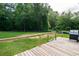 A spacious wooden deck featuring a grill offers an outdoor gathering and cooking space at 66 Johnstone Ln., Georgetown, SC 29440