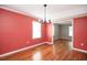 Dining room showcasing hardwood floors, a chandelier, and an open doorway to another room at 66 Johnstone Ln., Georgetown, SC 29440