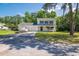 Charming two-story home with blue shutters, covered porch, two car garage, and a boat on the driveway at 66 Johnstone Ln., Georgetown, SC 29440