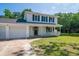 Charming two-story home with blue shutters, inviting front porch, well-manicured lawn, and attached two car garage at 66 Johnstone Ln., Georgetown, SC 29440