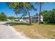 Attractive two-story home with blue shutters and an inviting front porch, set amidst lush landscaping at 66 Johnstone Ln., Georgetown, SC 29440