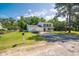 Charming two-story home with blue shutters, covered porch, two car garage, and a boat on the driveway at 66 Johnstone Ln., Georgetown, SC 29440