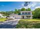 Charming two-story home with blue shutters, covered porch, two car garage, and a boat on the driveway at 66 Johnstone Ln., Georgetown, SC 29440