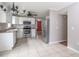 A modern kitchen featuring white cabinets, stainless steel appliances, and neutral tile flooring at 66 Johnstone Ln., Georgetown, SC 29440