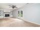A bright living room with a fireplace, shelving, ceiling fan and glass doors at 66 Johnstone Ln., Georgetown, SC 29440