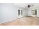 Living room featuring glass doors, ceiling fan, and view of the kitchen in the background at 66 Johnstone Ln., Georgetown, SC 29440
