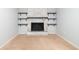 Neutral living room showcasing fireplace with white brick and black shelving at 66 Johnstone Ln., Georgetown, SC 29440