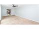 Neutral living room with ceiling fan and a partial view of the kitchen at 66 Johnstone Ln., Georgetown, SC 29440