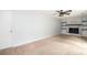 A comfortable living room featuring a fireplace, shelving, carpet and a ceiling fan at 66 Johnstone Ln., Georgetown, SC 29440